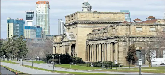  ?? MIKE DIBATTISTA/ NIAGARA FALLS REVIEW ?? With the Fallsview developmen­t in the background, the old Toronto Power Generating Station along the Niagara Parkway in Niagara Falls is one of four former power-plant buildings that the Niagara Parks Commission is hoping to redevelop. They are looking...