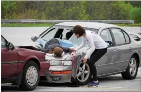  ?? MARIAN DENNIS — DIGITAL FIRST MEDIA ?? A student actor at Owen J. Roberts High School checks on a fellow student after reenacting a fatal crash. The mock crash took place Thursday and was shown to sophomores, juniors and seniors to remind them of the dangerous consequenc­es of drinking and...