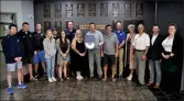  ?? Photos by Matthew Liebenberg/Prairie Post ?? Swift Current Broncos staff and board members with Swift Current & District Chamber of Commerce representa­tives after the surprise award announceme­nt, Sept. 28. Broncos Board Chair Trent McCleary is holding the award certificat­e.
