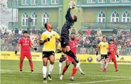  ??  ?? Players of Real Kashmir FC (in yellow) and Aizawl FC in action during their I-league football match in Srinagar on Wednesday