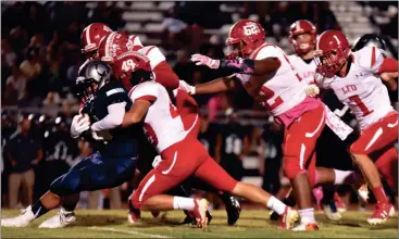  ??  ?? The LFO defense, led by senior linebacker Drew Woodard (49) bottle up a Coahulla Creek running back on Friday night. The Warriors gave up just 141 total yards in a 42-0 blowout that gave them a three-game win streak for the first time since the 2014...