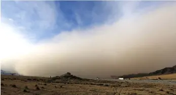  ??  ?? Picture shows a sandstorm rolling into Zhangye in China’s northweste­rn Gansu province. — AFP photo