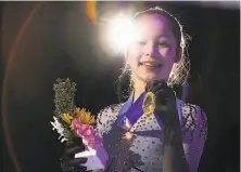  ?? Gregory Shamus / Getty Images ?? Alysa Liu, then 13, holds the gold medal she won in January at the U.S. Figure Skating Championsh­ips in Detroit.