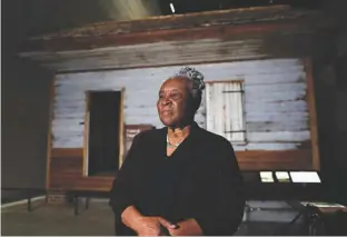  ?? Associated Press ?? n Isabell Meggett Lucas, 87, pauses Tuesday after an Associated Press interview at the National Museum of African American History in Washington in front of a slave cabin on display. Lucas was born in the two-room wood cabin, which dates to the 1850s....