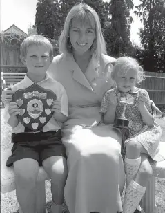  ??  ?? TV star Mary Nightingal­e with prizewinne­rs Thomas Davis and Samantha O’Connor in 1995. Ref:132818-5