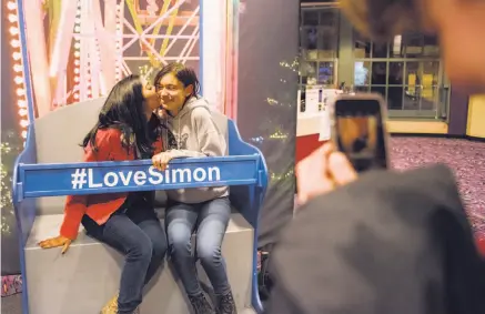  ?? Rosa Furneaux / Special to The Chronicle ?? Lick-Wilmerding High School students Olivia Jacob (left) and Annette Vergara-Tucker kiss as a classmate takes their picture after a screening of “Love, Simon,” starring Nick Robinson, below, at the AMC Van Ness last month.