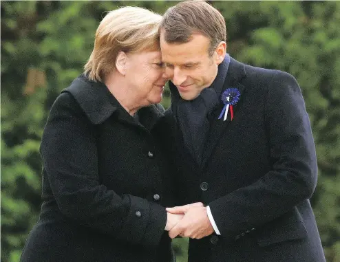  ?? — THE ASSOCIATED PRESS ?? German Chancellor Angela Merkel and French President Emmanuel Macron are head to head after unveiling a plaque in the Clairiere of Rethondes during a commemorat­ion ceremony for Armistice Day, 100 years after the end of the First World War, in Compiegne, north of Paris, on Saturday.