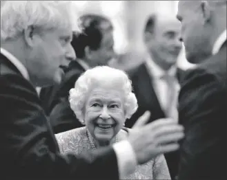  ?? AP PHOTO/ALASTAIR GRANT, POOL ?? Britain’s Queen Elizabeth II and Prime Minister Boris Johnson (left) greet guests at a reception for the Global Investment Summit in Windsor Castle, Windsor, England, on Tuesday.