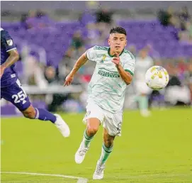  ?? John Raoux/Associated Press ?? Atlanta United’s Thiago Almada, right, gets position on a pass in front of Orlando City’s Antonio Carlos during the first half of an MLS match on Sept. 14 in Orlando, Fla.
