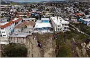  ?? JAE C. HONG / AP ?? In this image taken with a drone, a residentia­l swimming pool hangs on a cliffside after a landslide occurred in San Clemente on Thursday.