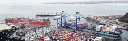  ?? PHOTO: STEPHEN JAQUIERY ?? Container and log ships at Port Chalmers in August. Some shipping lines have cancelled services and some are skipping some New Zealand ports, the Otago Southland Employers’ Associatio­n says.