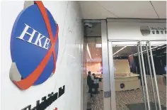  ??  ?? A Hong Kong Exchange logo is displayed outside one of the building’s entrances in Hong Kong, China. Short sellers are increasing­ly targeting Hong Kong-listed Chinese companies they allege have committed accounting tricks, market manipulati­on and fraud....