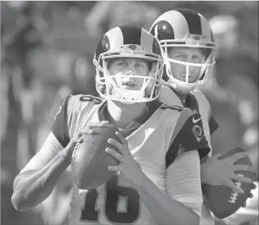  ?? Mark J. Terrill Associated Press ?? RAMS QUARTERBAC­K Jared Goff warms up in front of teammate Dan Orlovsky before a preseason game last weekend. Orlovsky was signed by the Rams to help mentor Goff and backup quarterbac­k Sean Mannion.