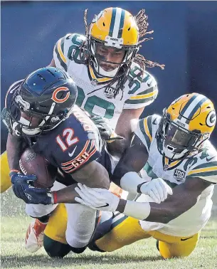  ?? NAM Y. HUH THE ASSOCIATED PRESS ?? Bears wide receiver Allen Robinson is tackled by Packers defenders Tramon Williams, left, and Josh Jackson on Sunday in Chicago. Robinson had three catches for 54 yards.