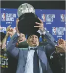  ?? ELISE AMENDOLA/ASSOCIATED PRESS ?? Cavaliers coach Tyronn Lue hoists the trophy after beating the Celtics in Game 7 of the Eastern Conference Finals on Sunday in Boston.