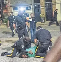  ?? ?? MOVE ON, NOTHING TO SEE: Police arrest demonstrat­ors during a protest against the police killing of Andrew Brown Jr in Elizabeth City, North Carolina, on April 28.