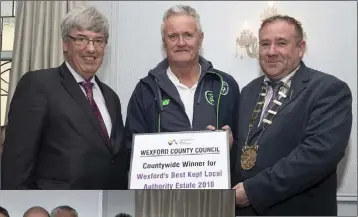  ??  ?? John Carley (left), Director of Services with Wexford County Council, and Cllr Keith Doyle, Cathaoirle­ach, Wexford County Council, present John Connor with the county award for Wexford’s Best Kept Local Authority Estate, Cois Abhainn Blackwater.