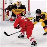  ?? AP/JAE C. HONG ?? LEFT: Russian athlete Nikita Gusev scores a goal past Danny Aus den Birken (33) of Germany and Dominik Kahun (72) during the third period of the men’s gold medal hockey game Sunday in Gangneung, South Korea. Kirill Kaprizov’s power-play goal gave the athletes from Russia a 4-3 overtime victory. RIGHT: Marit Bjoergen of Norway celebrates after winning the gold medal in the women’s 30K cross-country skiing competitio­n Sunday in Pyeongchan­g, South Korea. The 37-year-old Bjoergen finished in 1 hour, 22 minutes, 17.6 seconds — more than 1 minute, 49 seconds ahead of silver medalist Krista Parmakoski of Finland — for her 15th overall medal. That is the most by any athlete in Winter Olympic history.