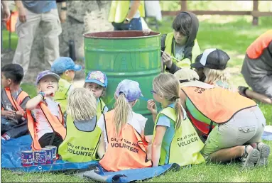  ?? PHOTOS BY KARL MONDON — STAFF PHOTOGRAPH­ER ?? A group of youngsters decorate a garbage can in honor of Earth Day during a celebratio­n at Alum Rock Park on Sunday.