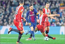  ??  ?? Barcelona's Lionel Messi (C) vies with Girona's Juanpe Ramirez (L), Bernardo Espinosa and Girona's Spanish Alex Granell during the Spanish league football at the Camp Nou stadium in Barcelona.