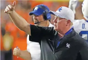  ?? AP PHOTO/JOHN RAOUX ?? Kentucky football coach Mark Stoops has a discussion with players during a timeout at the 2018 Florida game. The Wildcats went 10-3 last season, with one of the highlights a win at Florida that ended Kentucky’s 31-year losing streak in the series.