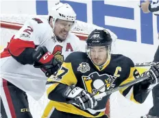  ?? GENE J. PUSKAR/THE CANADIAN PRESS ?? Ottawa Senators’ Dion Phaneuf checks Pittsburgh Penguins’ Sidney Crosby in the crease during the first period of Game 1 of the Eastern Conference final in the NHL hockey Stanley Cup playoffs.