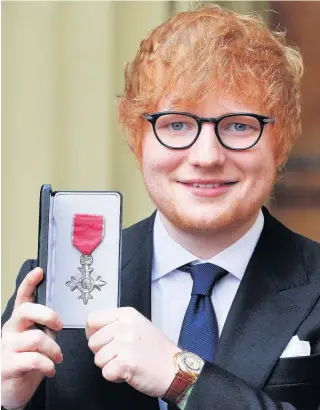  ??  ?? > Singer Ed Sheeran with his MBE medal presented to him by the Prince of Wales