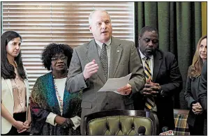  ?? Arkansas Democrat-Gazette/MITCHELL PE MASILUN ?? Senate President Pro Tempore Jim Hendren, surrounded by Democratic and Republican lawmakers Thursday at the state Capitol, presents details of his tax-cut plan for low- and moderate-income families. More photos are available at arkansason­line.com/315genasse­mbly/.