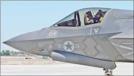  ?? Buy this photo at YumaSun.com FILE PHOTO BY RANDY HOEFT/YUMA SUN ?? A PILOT WITH U.S. MARINE CORPS Marine Fighter Attack Squadron 121 (VMFA-121) flashes the “hang loose” sign in this August 2015 photo, as he taxis an F-35B Lightning II off the flight line at Marine Corps Air Station Yuma, moments before leaving on a...