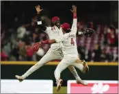  ?? CAROLYN KASTER – THE ASSOCIATED PRESS ?? Reds shortstop Elly De La Cruz, back, and second baseman Santiago Espinal celebrate Tuesday’s win.