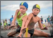  ??  ?? Ethan Peacock and Oliver Goble compete for the same flag in the beach flags event.