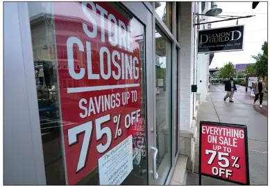  ?? (AP) ?? A business storefront in Dedham, Mass., announces a store closing and sale in early September. Economists believe the economy will expand at an annual rate of 30% in the current quarter as businesses have reopened and millions of people have gone back to work.