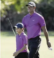  ?? PHELAN M. EBENHACK AP ?? Tiger Woods and his son Charlie walk a course in December. The HBO documentar­y ‘Tiger’ chronicles the golfer’s life.