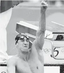  ?? MARK BAKER/ASSOCIATED PRESS ?? Michael Phelps celebrates after winning gold in the final of the men's 100-meter freestyle during the Beijing 2008 Olympics.