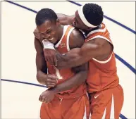  ?? Kathy Batten / Associated Press ?? Texas guards Andrew Jones ( 1) and Courtney Ramey ( 3) celebrate after Jones scored against West Virginia during the second half on Saturday in Morgantown, W. Va. Jones was playing for the first time since being diagnosed with leukemia three years ago.