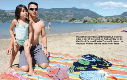  ??  ?? Thanh Pham and his daughter Isabella, 5 of Vernon enjoy a day at the beach at Tugboat Bay in the Waterfront Park on Monday. The beach opened to the public with the removal of the water dams.
