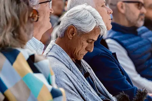  ?? Photos by Jessica Christian/The Chronicle ?? Olympic Gold Medal diver Greg Louganis listens to speakers during the annual World AIDS Day observance held Friday at the National AIDS Memorial Grove in Golden Gate Park in San Francisco.