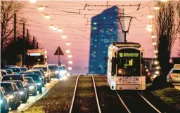  ?? MICHAEL PROBST/AP ?? A tram passes traffic as it heads toward the European Central Bank in Frankfurt, Germany. Eurozone inflation persists but is down from its October peak of 10.6%.