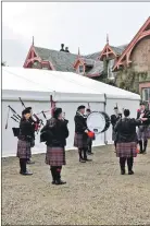  ?? 01_B43funeral­10 ?? The Isle of Arran Pipe Band perform outside the marquee at Strabane.