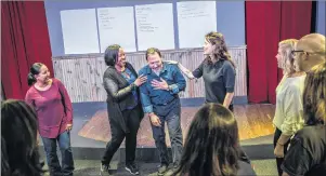  ?? CP PHOTO ?? Kevin Frank, artistic director of training and education for Second City Canada, centre, and Christy Bruce, instructor, centre right, run a class in Toronto earlier this year. Second City has now launched a new improve class specifical­ly for teenage...
