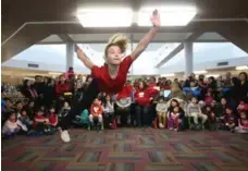  ??  ?? Victoria Rusakova, member of Taishan School of Martial Arts, executes a jump kick at the festivitie­s at the Milliken Mills library.