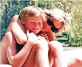  ??  ?? In this photo made available by Kensington Palace from the personal photo album of the late Diana, Princess of Wales, shows the princess and Prince Harry on holiday, and features in the new ITV documentar­y 'Diana, Our Mother: Her Life and Legacy.'