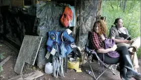  ?? Darrell Sapp/Post-Gazette ?? Karie Smitherman of Seattle and Josh Michener of Idaho sit in protest in their tree outpost Tuesday on Stephen and Ellen Gerhart’s property.