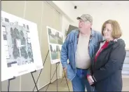  ?? (NWA Democrat-Gazette/Lynn Kutter) ?? Jay and Sandy Norton look at renderings for a new community building on Lincoln Square during an informatio­nal meeting held recently at the Lincoln Public Library.