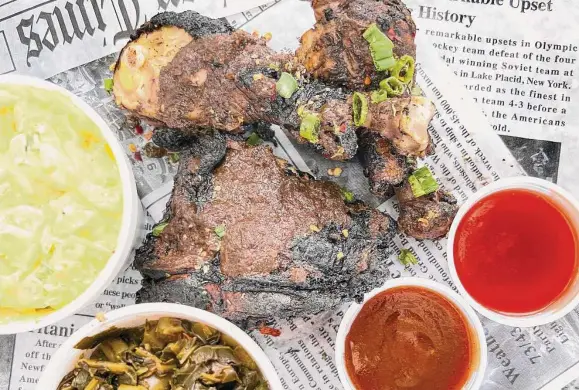  ?? Photos by Mike Sutter/Staff ?? A three-piece jerk chicken meal is served with potato salad and collard greens. The jerk chicken remains worthy of the national accolades heaped on it.