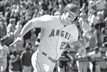  ?? Jayne Kamin-Oncea Getty Images ?? MIKE TROUT rounds the bases after hitting a 458-foot grand slam, the third-longest home run of his career, in the fourth inning against Texas. He has four home runs in his first three home games.