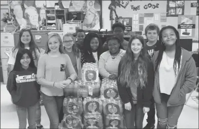  ??  ?? Water: Junction City’s Junior High FBLA chapter stand with a water donation for Tallulah, La. students who are experienci­ng a water shortage.