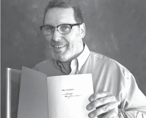  ?? Rod Aydelotte/Waco Tribune-Herald via AP ?? ■ Waco Independen­t School District social studies specialist Robert Glinski holds a signed copy of Harry S. Truman’s 1960 memoir, “Mr. Citizen,” found recently in the Waco High School library in Waco, Texas.