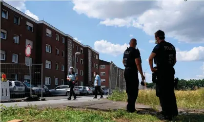  ??  ?? German police officers stand near the homes of employees of the Tönnies factory, Europe’s largest meat-processing plant, on Monday. Photograph: Ina Fassbender/AFP/Getty Images