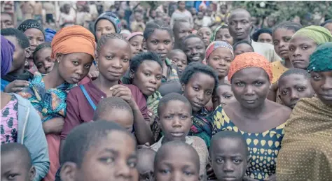  ?? ALEXIS HUGUET/AGENCE FRANCE-PRESSE ?? DOZENS of war-displaced people stand in the courtyard of an elementary school where they have taken refuge in Minova, South Kivu province, in the East of the Democratic Republic of Congo.